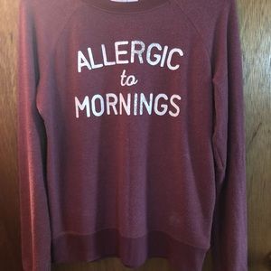 Rose color sweatshirt “allergic to mornings”